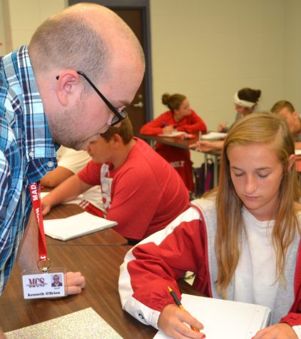 First year math teacher, Mr. O'brien assists Sophomore Sydney Hammock in class