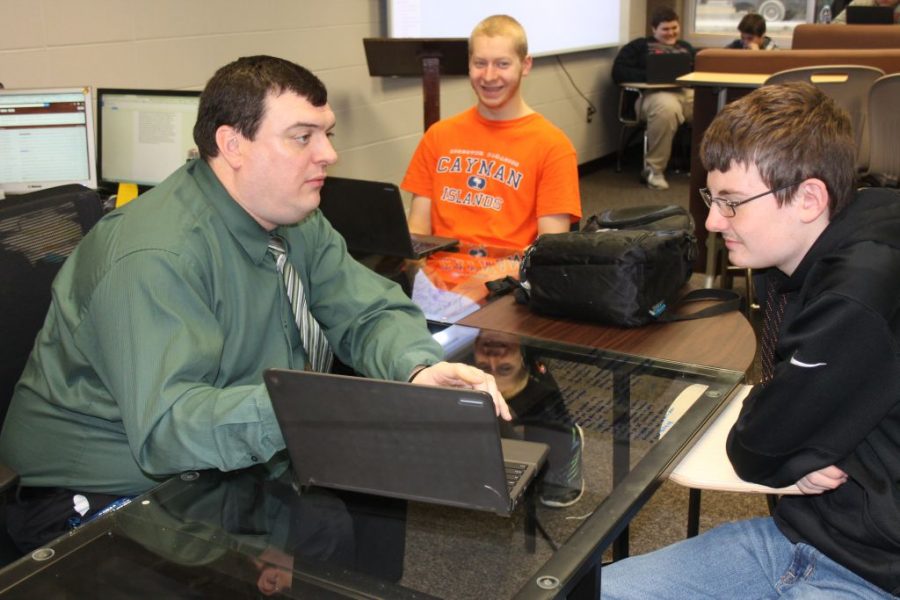 Mr.  Lawhead in a one-on-one conference with a student.
