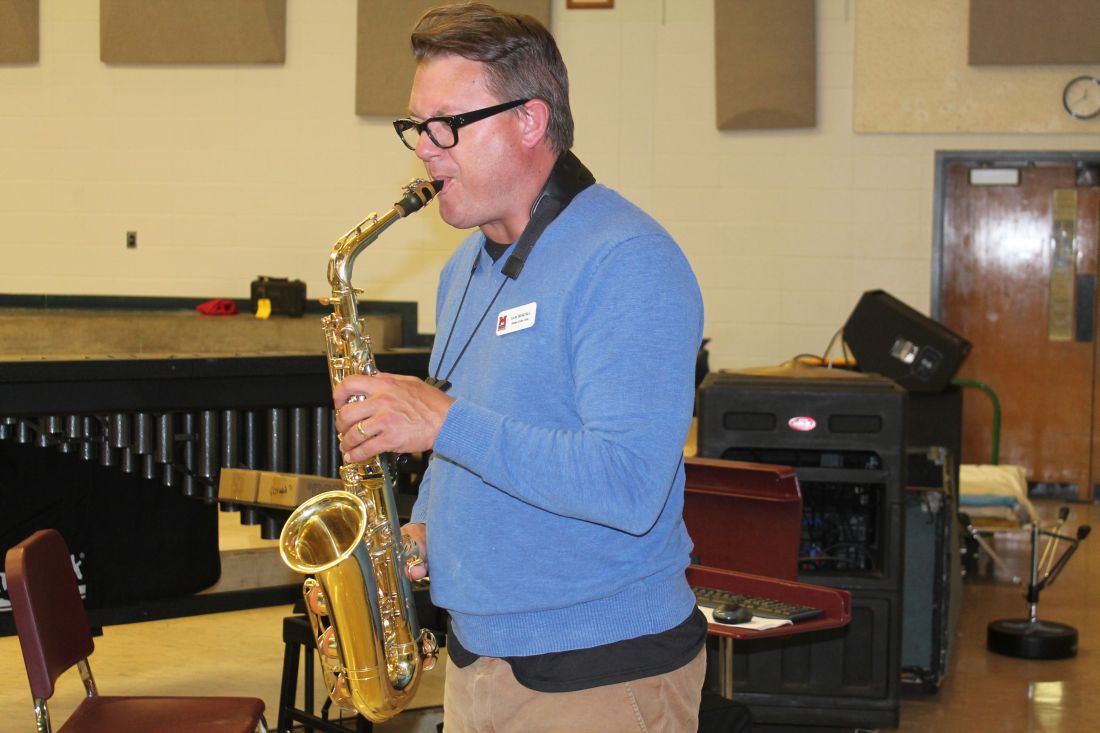 New MCHS Band Director Sam Bortka demonstrates the saxophone