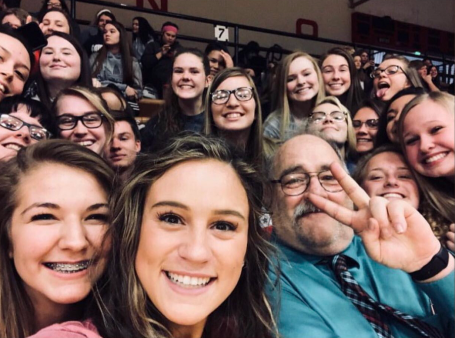 Mr. Rusk joins the student sections at a basketball game