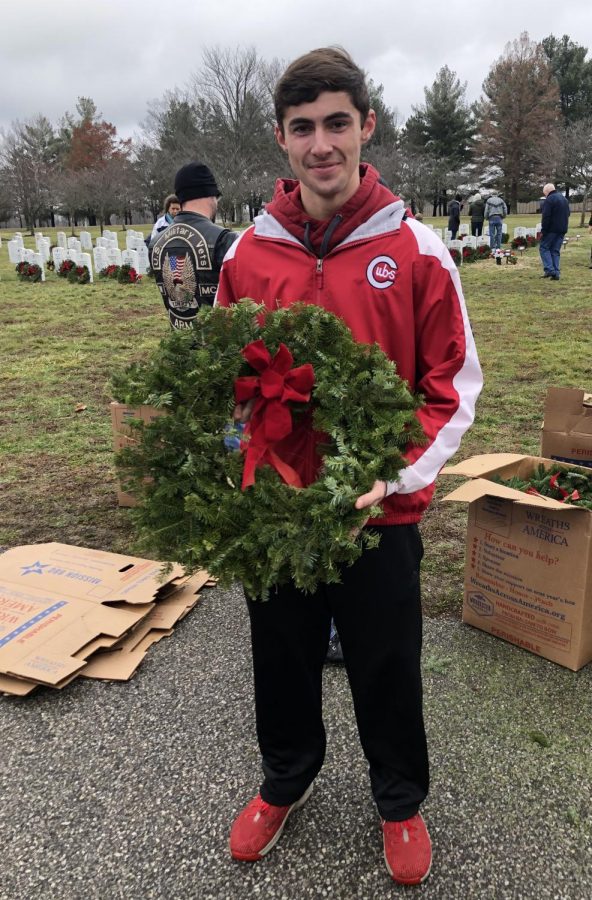 MCHS APUSH student Luke McCarty with a wreath for fallen veterans for the holidays