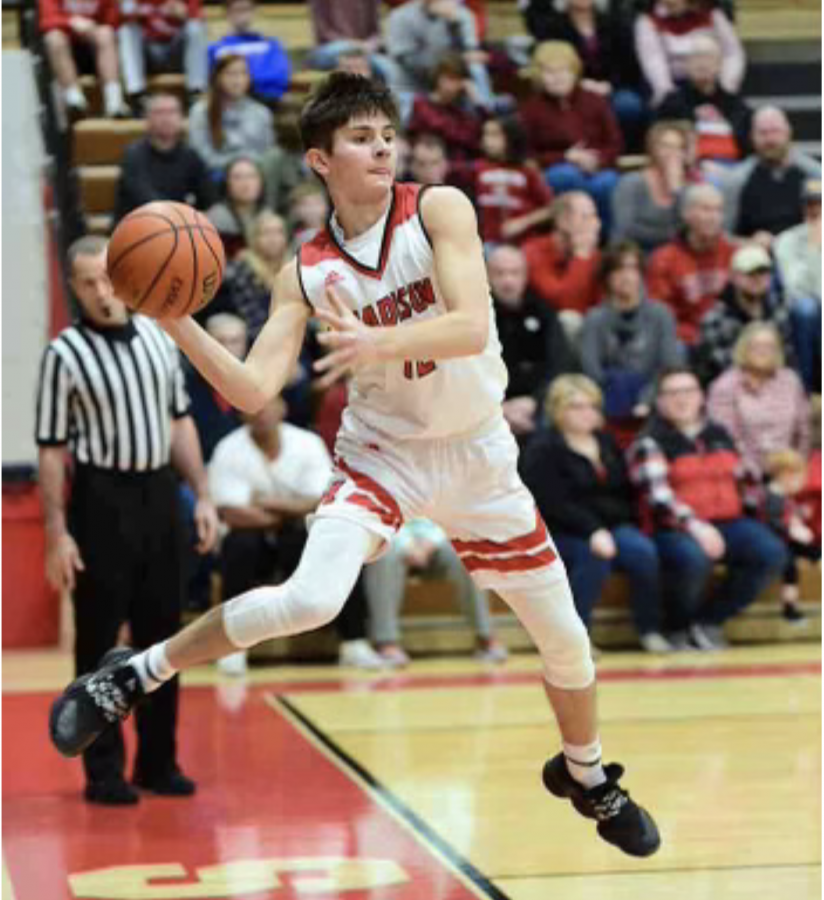 MCHS senior basketball player Luke Miller saves the ball from going out of bounds.