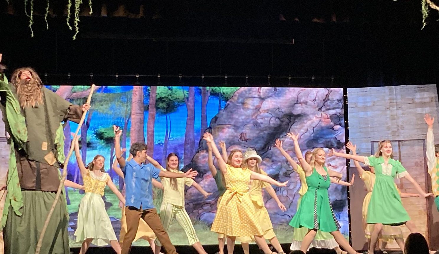 Madisonian reporter Zoe Bullock (center, gold dress) performs with the cast of Big Fish
