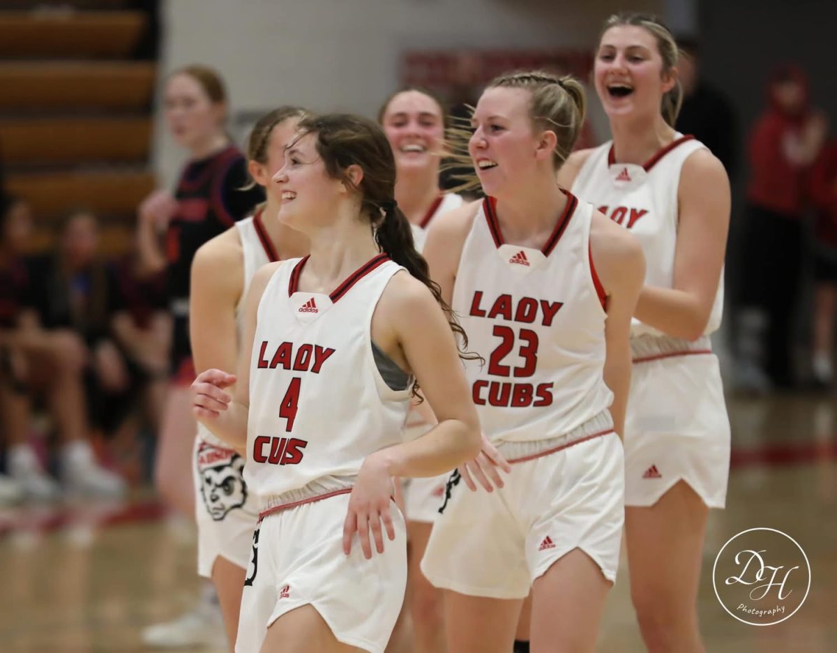 The newest member to Madison's 1,000 point club, Juliana Davis (left), laughs with teammates Kylie Montgomery (back), Addi Roark (23), and Mylee McQueary (right).