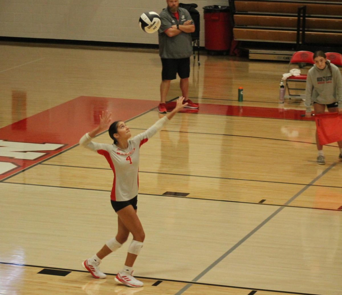 MCHS Senior Audrey Miller serves up the volleyball.
